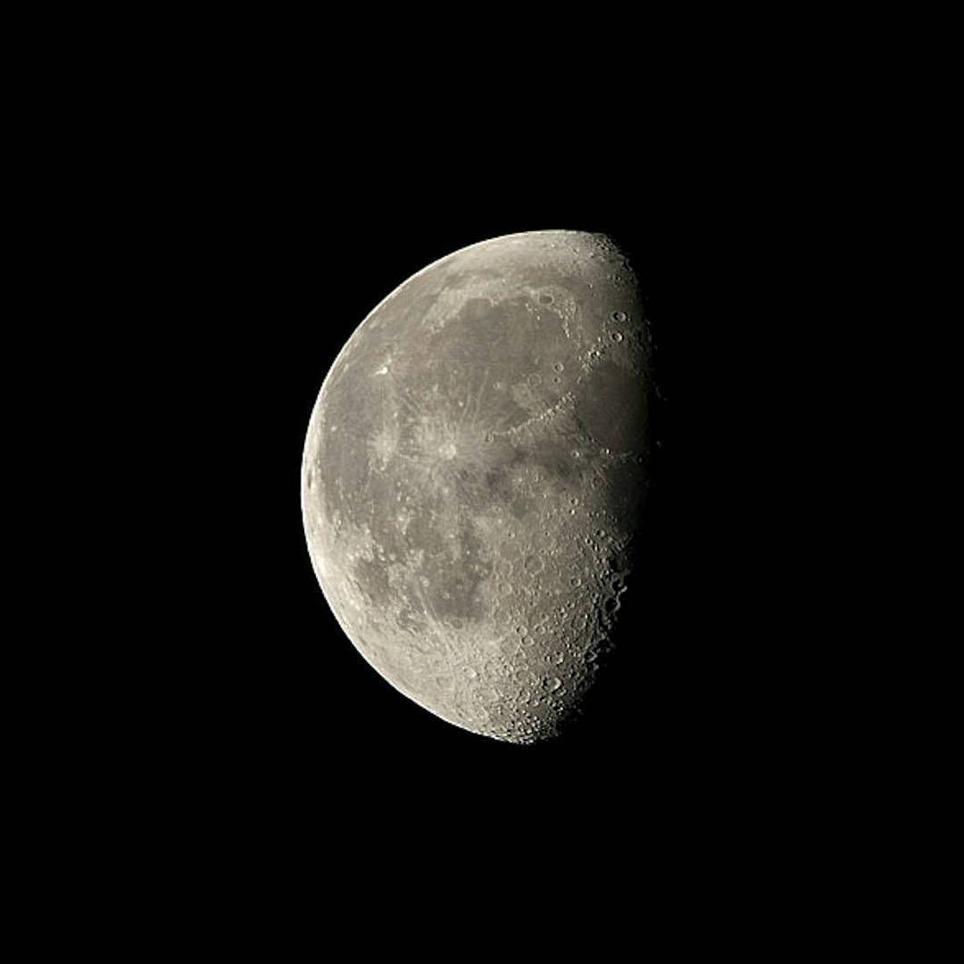 Waxing gibbous moon against a black sky, showing cratered surface detail along the terminator line.