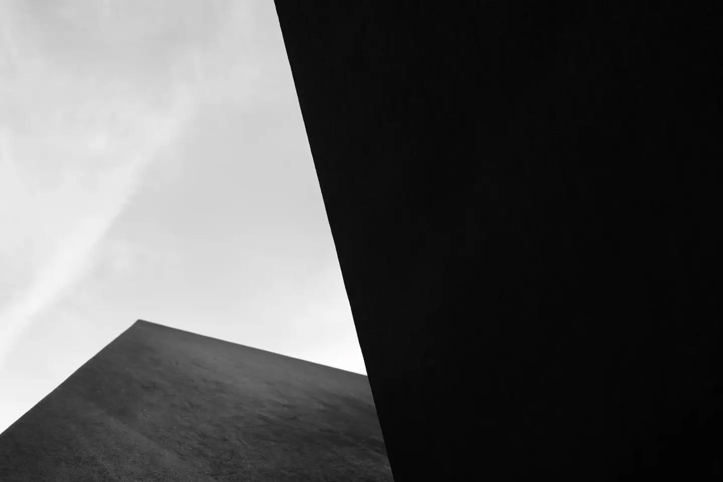 Black and white photograph with abstract, geometric composition and dramatic shadows