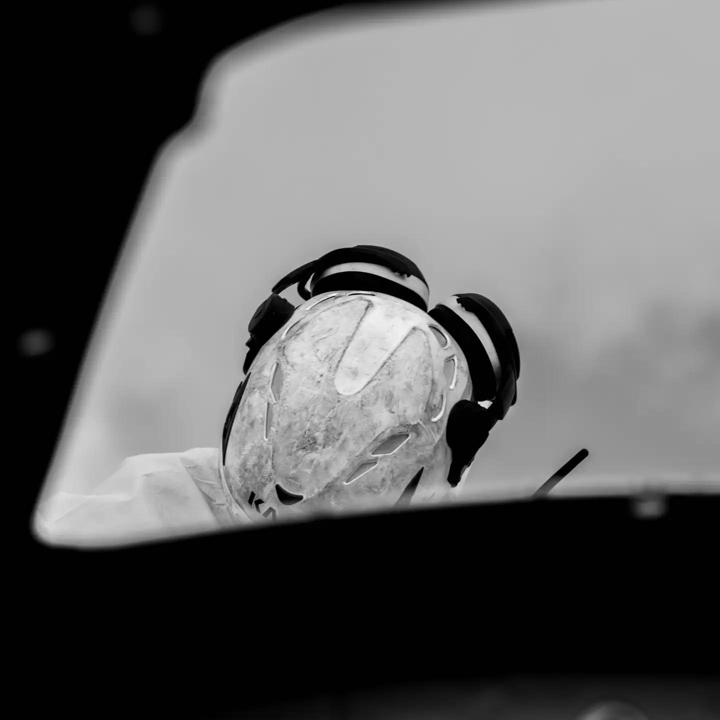 Black and white photograph exploring the symbiosis between humans and machines, with a wind turbine present.