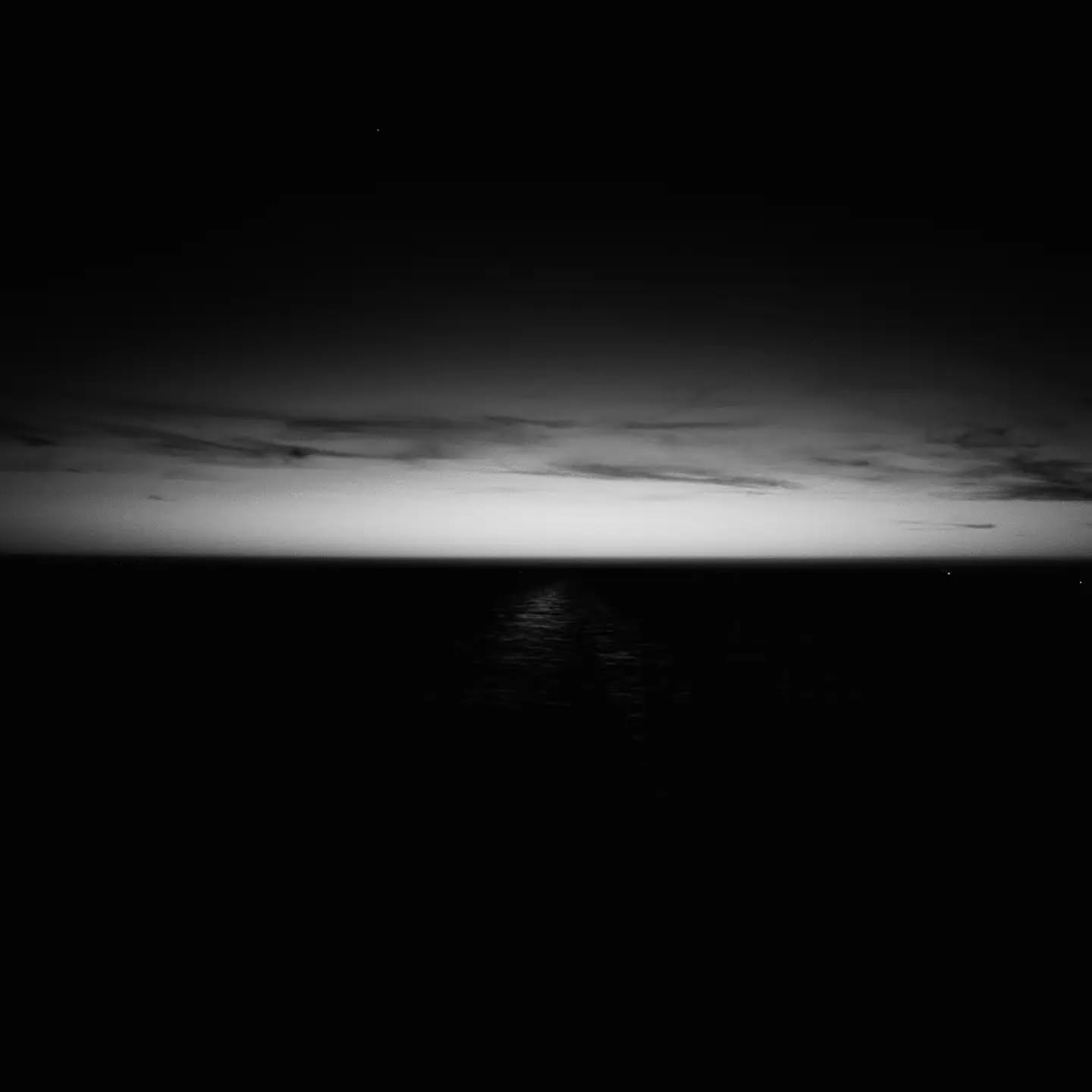 Black-and-white portrait of a person in a space, evoking a moment of transformation.