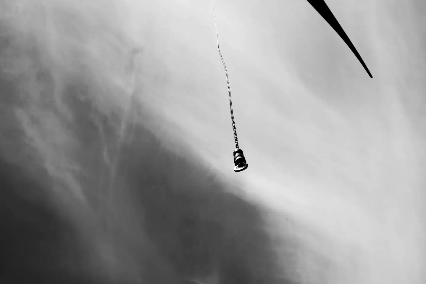 Black and white photograph exploring negative space, with abstract, symbolic imagery evoking a solemn, reflective mood.